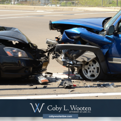 Two cars involved in a head-on collision in Fort Worth, with visible front-end damage to both vehicles.