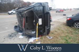 After an SUV rollover accident in Dallas, a crushed vehicle lies on its side
