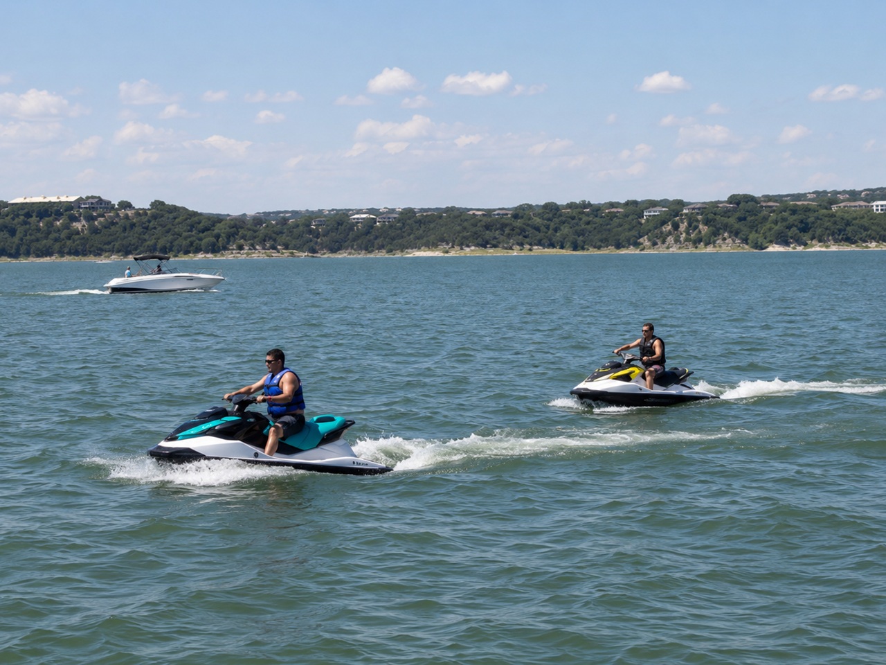 Two riders on personal watercraft navigate a Texas Hill Country lake on a sunny summer afternoon alongside a motorboat, depicting the recreational jet ski and personal watercraft traffic on Texas lakes where collisions, reckless operation, and operator negligence can give rise to serious injury claims under the Texas Water Safety Act.